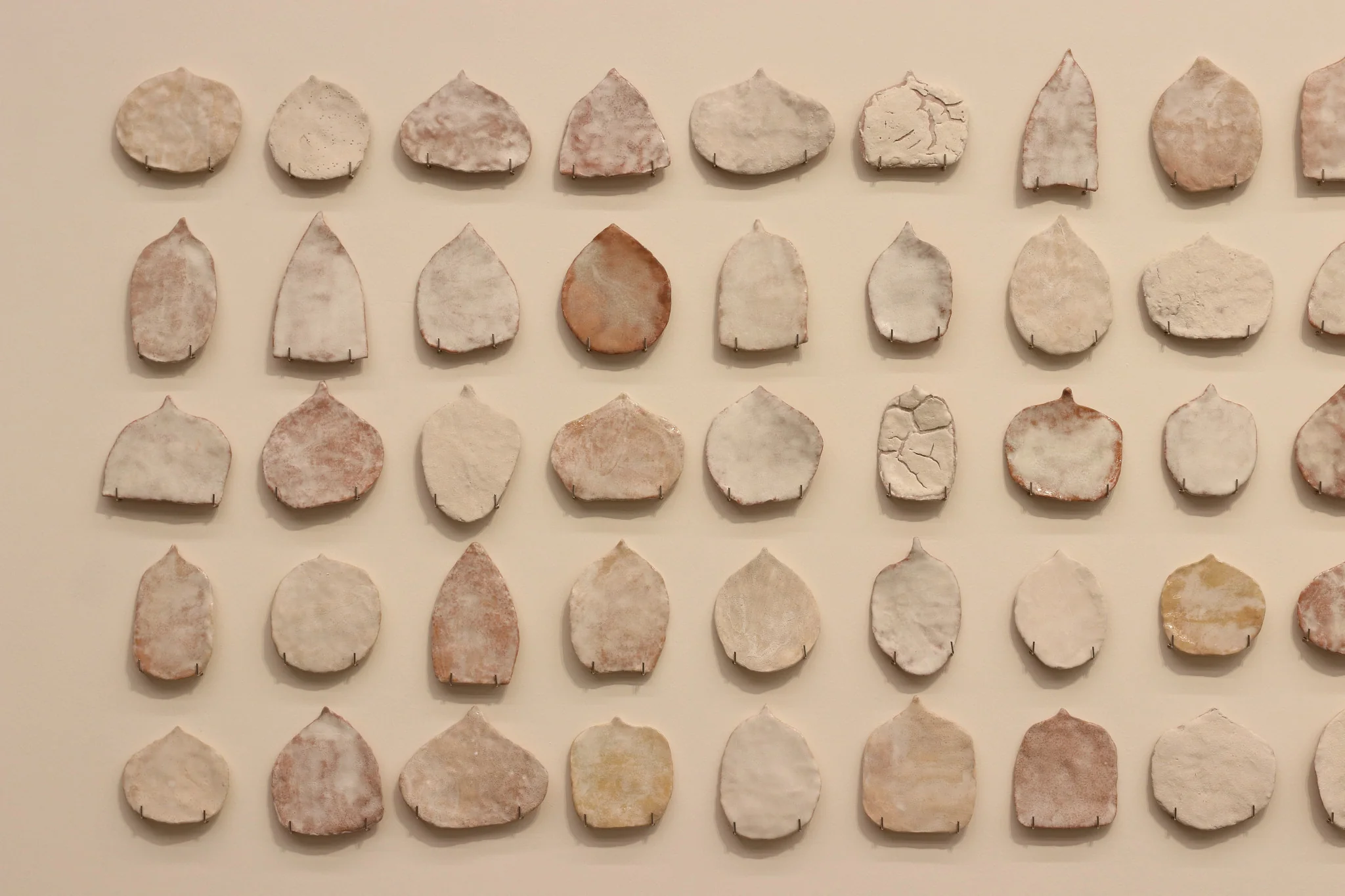 "Pinaree Sanpitak, Precariously Sacred, 2000-2002. Glazed terracotta
, dimensions variable. Photo: Aroon Peampoonsopon . Courtesy of the Jim Thompson Art Center and the James H.W. Thompson Foundation © Jim Thompson Art Center