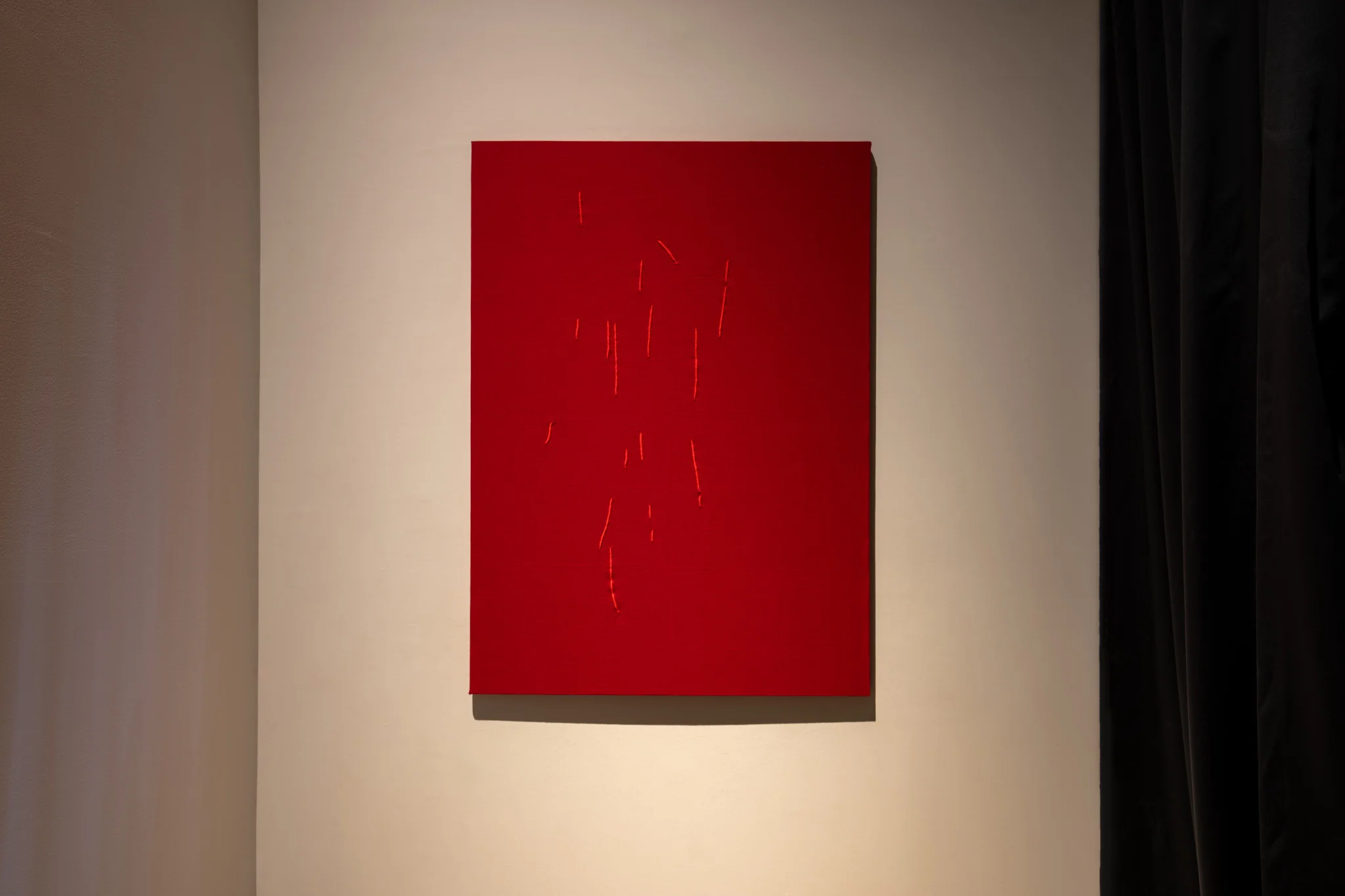Kader Attia, Untitled (Mirrors), 2024. Red canvas,  132 x 95 cm. Photo: Swita Uancharoenkul. Courtesy of the Jim Thompson Art Center and the James H.W. Thompson Foundation © Jim Thompson Art Center