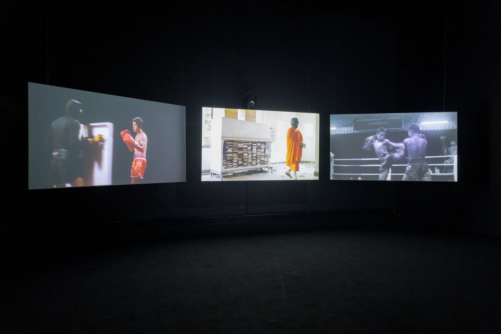 Chulayarnnon Siriphol  with Jean Sit Arjan Jo  Collective, and  Kasamaponn Saengsuratham, Red Eagle Sangmorakot: No More Hero in His Story, 2024. 3-channel video installation, 25 min, Dimension variable. Photo: BACC. Courtesy of BACC © BACC